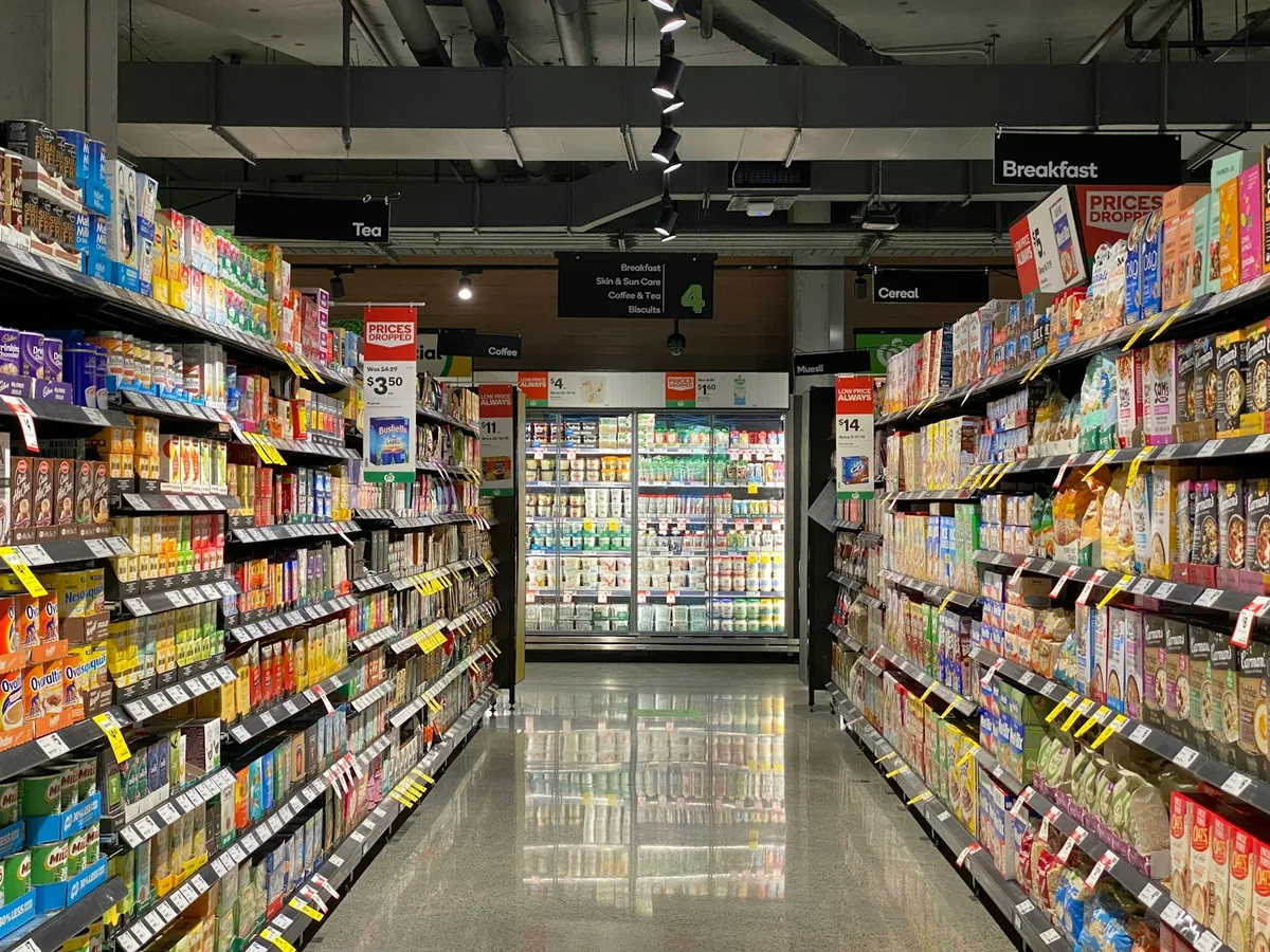 Stocked supermarket aisle shelves